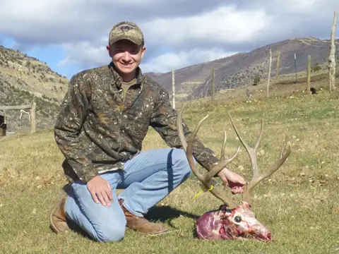Wyatt Case with his elk in a mountain meadow