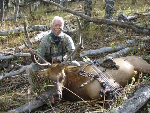 Bow hunter with a bull elk